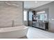 Elegant bathroom featuring double vanity, large mirror, and free-standing tub at 2465 Henderson Rd, Tucker, GA 30084