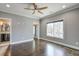 Spacious bedroom with wood floors, ceiling fan, and ample closet space at 2465 Henderson Rd, Tucker, GA 30084