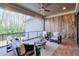 Relaxing covered patio with seating area, wood-paneled wall, and view of trees at 2465 Henderson Rd, Tucker, GA 30084