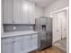 Kitchen with stainless steel refrigerator and gray cabinets at 2465 Henderson Rd, Tucker, GA 30084