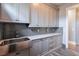 Laundry room with farmhouse sink and gray cabinets at 2465 Henderson Rd, Tucker, GA 30084