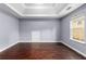 Bright bedroom with hardwood floors and a window at 1598 Blue Spruce Ln, Conyers, GA 30012