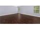Large bedroom with hardwood floors and two windows at 1598 Blue Spruce Ln, Conyers, GA 30012