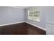 Simple bedroom with dark hardwood floors and neutral walls at 1598 Blue Spruce Ln, Conyers, GA 30012