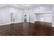 Versatile bonus room with hardwood floors and access to other rooms at 1598 Blue Spruce Ln, Conyers, GA 30012