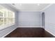 Simple dining room with dark hardwood floors and wainscoting at 1598 Blue Spruce Ln, Conyers, GA 30012