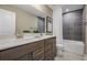 Clean bathroom with double vanity, shower, and dark tile at 165 Poppy St, Mcdonough, GA 30253