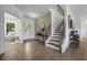 Hardwood floors, staircase, and view into adjacent sitting area at 165 Poppy St, Mcdonough, GA 30253