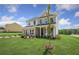Two-story home with brick and siding, a front porch, and landscaped lawn at 165 Poppy St, Mcdonough, GA 30253