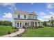 Two-story home with brick and siding, a front porch, and landscaped lawn at 165 Poppy St, Mcdonough, GA 30253