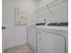 Bright laundry room with washer, dryer, and shelving at 165 Poppy St, Mcdonough, GA 30253