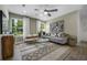 Bright living room with a comfy sofa and large window at 165 Poppy St, Mcdonough, GA 30253