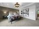 Spacious main bedroom with a large bed, window, and modern art at 165 Poppy St, Mcdonough, GA 30253