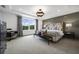 Main bedroom with large window, wood-paneled wall, and plush bed at 165 Poppy St, Mcdonough, GA 30253