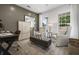Home office with wood-paneled wall, two armchairs, and a large rug at 165 Poppy St, Mcdonough, GA 30253