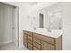 Double vanity bathroom with a large mirror at 305 Foxglove Way, Mcdonough, GA 30253