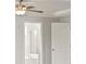 Bedroom with door to bathroom and ceiling fan at 305 Foxglove Way, Mcdonough, GA 30253