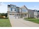 Two-story house with attached garage and landscaping at 305 Foxglove Way, Mcdonough, GA 30253