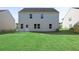 Rear view of house, showcasing backyard and patio at 305 Foxglove Way, Mcdonough, GA 30253