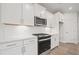 Bright kitchen featuring white cabinets and stainless steel appliances at 305 Foxglove Way, Mcdonough, GA 30253