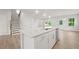 Modern kitchen island with white cabinets and quartz countertops at 305 Foxglove Way, Mcdonough, GA 30253