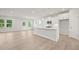 Modern kitchen with white cabinets, island, and hardwood floors at 305 Foxglove Way, Mcdonough, GA 30253