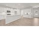 Open concept kitchen with white cabinets and large island at 305 Foxglove Way, Mcdonough, GA 30253