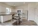 Modern kitchen featuring white cabinets, granite countertops, and a kitchen island at 7713 Sudbury Cir, Covington, GA 30014