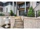 Stone steps lead to a patio with a brick wall and landscaping at 92 Sheridan Dr, Atlanta, GA 30305
