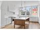 Modern kitchen with white cabinets, a large island, and hardwood floors at 92 Sheridan Dr, Atlanta, GA 30305
