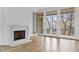 Light-filled living room with fireplace and French doors leading to deck at 92 Sheridan Dr, Atlanta, GA 30305