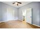 Spacious bedroom with light grey walls, ceiling fan, and wood-look flooring at 1382 Elizabeth Ln, East Point, GA 30344