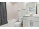 A bathroom with a shower-tub combo, tile walls and modern fixtures at 316 Foxglove Way, Mcdonough, GA 30253