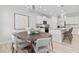 Bright dining room featuring a round wooden table and gray chairs at 316 Foxglove Way, Mcdonough, GA 30253