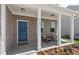 Inviting front porch with brick columns and comfortable seating at 316 Foxglove Way, Mcdonough, GA 30253