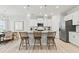 Modern kitchen with white cabinets, granite countertops, stainless steel appliances, and a stylish island with barstool seating at 316 Foxglove Way, Mcdonough, GA 30253