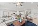 Inviting living space featuring a comfortable sectional sofa, stylish decor, and an open layout to the kitchen at 316 Foxglove Way, Mcdonough, GA 30253