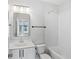 Clean bathroom with white subway tiles, a bathtub, and a vanity with modern fixtures at 457 Parkway Ne Dr, Atlanta, GA 30308
