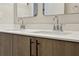 Modern bathroom with dual sinks, light wood cabinets, and chrome faucets at 457 Parkway Ne Dr, Atlanta, GA 30308