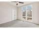 Bright bedroom featuring large windows and grey carpeting at 457 Parkway Ne Dr, Atlanta, GA 30308