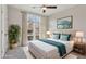 Virtually staged bedroom with large windows and ceiling fan at 457 Parkway Ne Dr, Atlanta, GA 30308