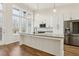 Modern kitchen with white cabinets, large island, and stainless steel appliances at 457 Parkway Ne Dr, Atlanta, GA 30308