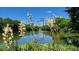 Peaceful lake view with cityscape reflection and blooming yucca plants at 457 Parkway Ne Dr, Atlanta, GA 30308