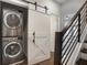 Stacked LG washer and dryer in a laundry room with a white barn door at 457 Parkway Ne Dr, Atlanta, GA 30308