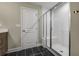 Modern bathroom with a large walk-in shower and dark tile floors at 344 Foxglove Way, Mcdonough, GA 30253