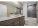 Clean bathroom with a double vanity, dark gray tile, and a bathtub at 344 Foxglove Way, Mcdonough, GA 30253
