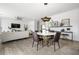 Elegant dining area with a round table, modern chandelier, and hardwood floors at 344 Foxglove Way, Mcdonough, GA 30253