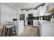 Modern kitchen with white cabinets, stainless steel appliances, and an island at 344 Foxglove Way, Mcdonough, GA 30253