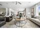 Open concept living room with hardwood floors, a fireplace, and comfortable seating at 344 Foxglove Way, Mcdonough, GA 30253