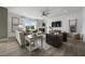 Spacious living room with a fireplace, hardwood floors, and a large TV at 344 Foxglove Way, Mcdonough, GA 30253